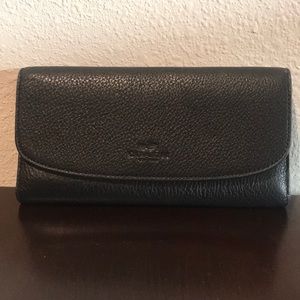 Black trifold Coach wallet with checkbook insert